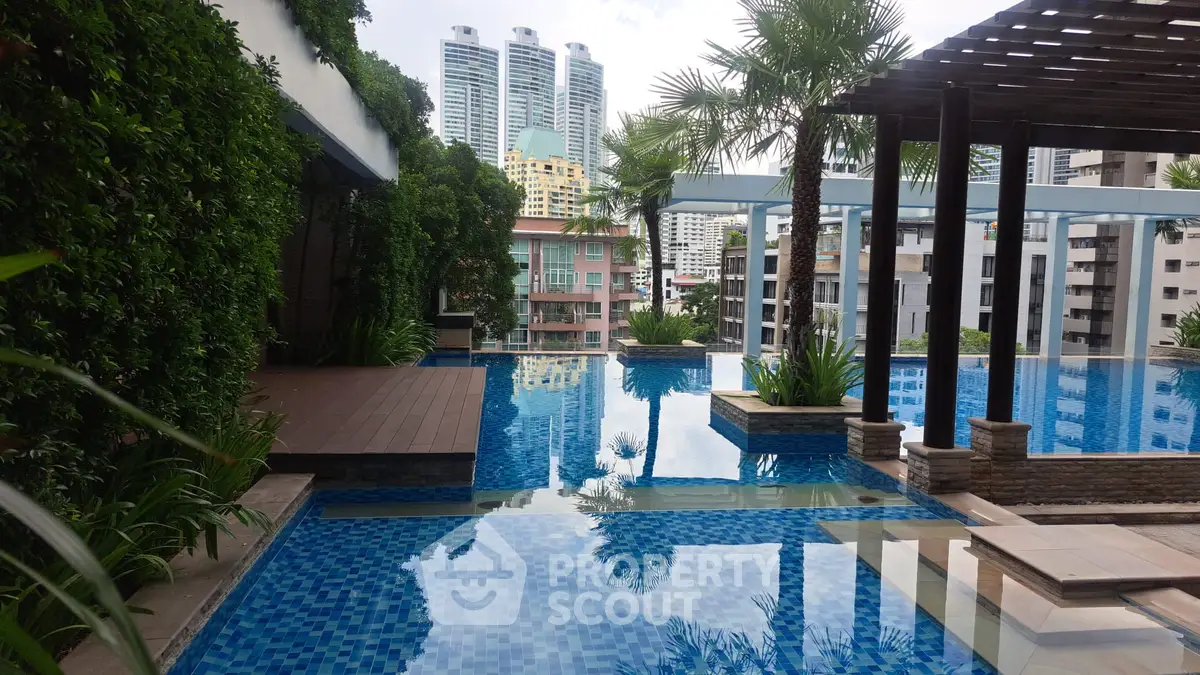 Luxurious rooftop pool with stunning cityscape views and lush greenery, perfect for relaxation and leisure.