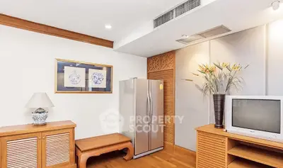 Charming living room with wooden furniture and modern appliances