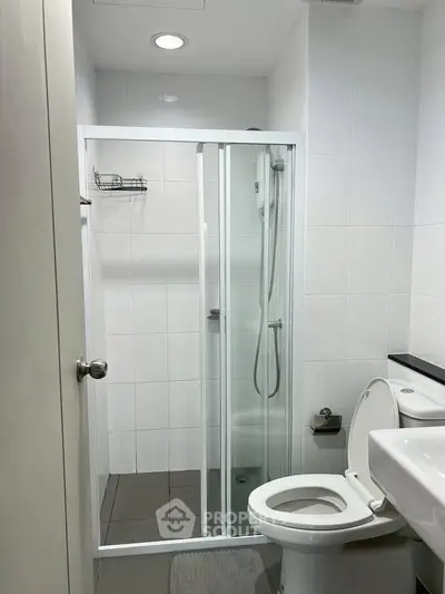 Modern bathroom with sleek shower enclosure and contemporary fixtures.