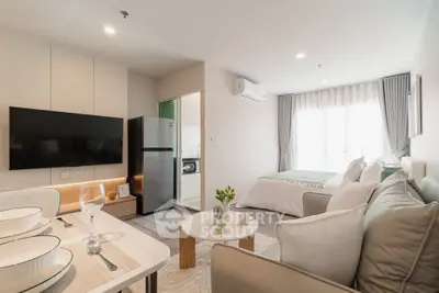 Modern studio apartment with open layout, featuring cozy living area and stylish kitchen.