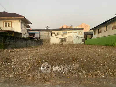 Vacant land plot ready for development in a residential neighborhood.