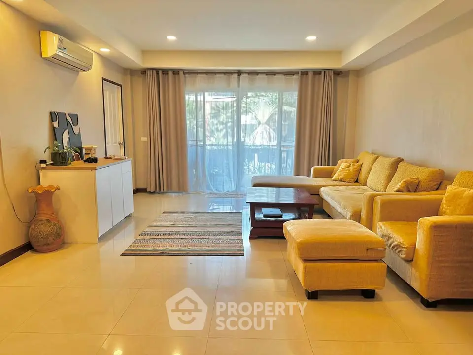 Spacious living room with modern decor and large windows for natural light