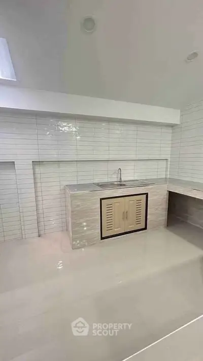 Modern minimalist kitchen with sleek tile design and ample counter space