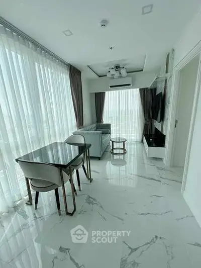 Luxurious modern living room with marble flooring and elegant furnishings.