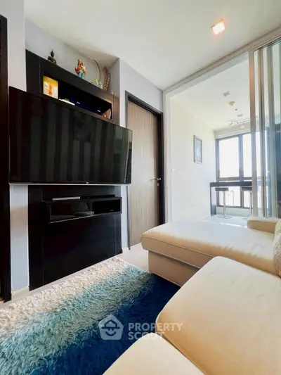 Modern living room with sleek TV setup and cozy seating area