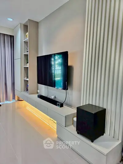 Modern living room with sleek TV setup and ambient lighting
