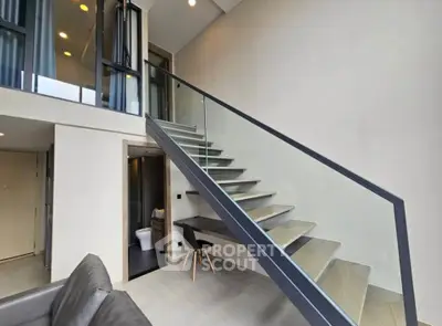 Modern duplex interior with sleek staircase and open layout