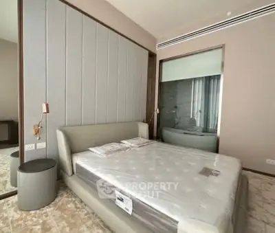 Modern bedroom with sleek design and luxurious bed in a stylish apartment.
