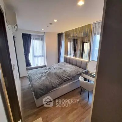 Modern bedroom with stylish decor and large windows for natural light