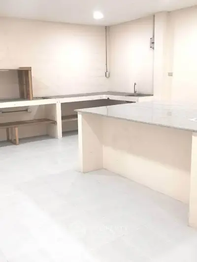 Spacious kitchen with open layout and ample counter space, ideal for culinary enthusiasts.