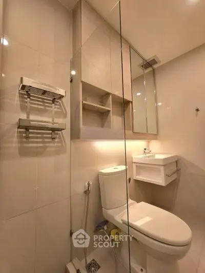 Modern bathroom with sleek fixtures and glass shower enclosure