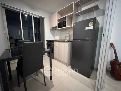 Modern kitchen with sleek appliances and dining area in a stylish apartment