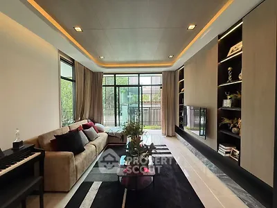 Luxurious modern living room with elegant decor and large windows offering natural light.
