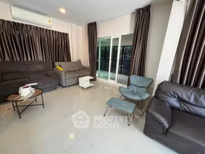 Spacious living room with modern furniture and large windows for natural light