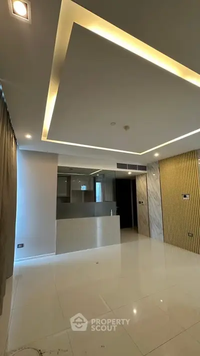 Modern living room with sleek ceiling lights and marble accents