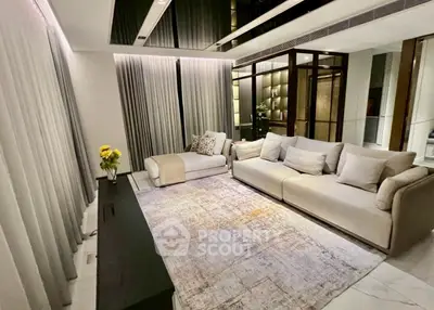 Luxurious modern living room with elegant decor and spacious seating area.