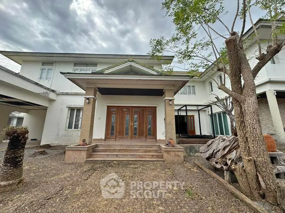 Spacious two-story house with elegant entrance and large windows