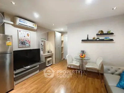 Modern living room with stylish decor and open layout, featuring a cozy dining area and sleek appliances.