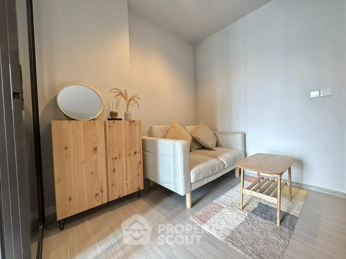 Cozy living room with modern sofa, wooden cabinet, and stylish decor in a bright apartment.
