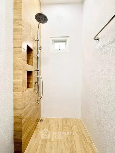 Modern bathroom with sleek shower design and wooden accents