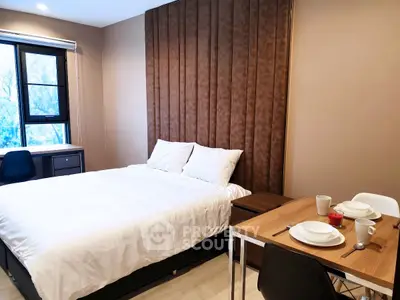 Modern bedroom with cozy dining area and large window view