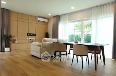 Spacious modern living room with elegant dining area and large windows