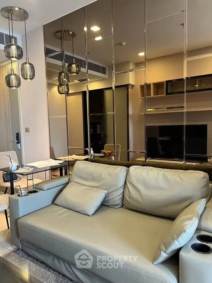 Modern living room with stylish sofa and mirrored wall accents