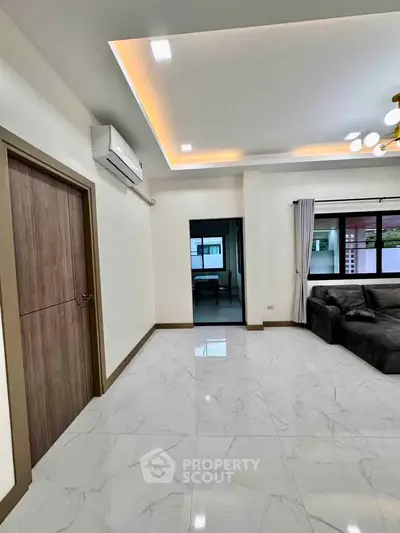 Modern living room with sleek marble flooring and stylish ceiling lights