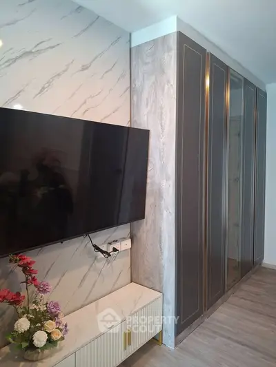 Modern living room with wall-mounted TV and stylish cabinetry