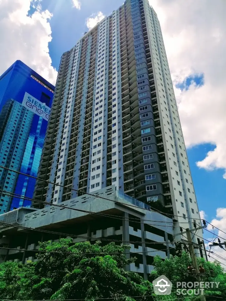 Stunning high-rise residential building with modern architecture against a clear blue sky.