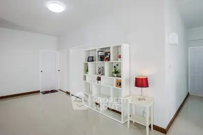 Spacious modern living room with sleek white shelving and elegant decor