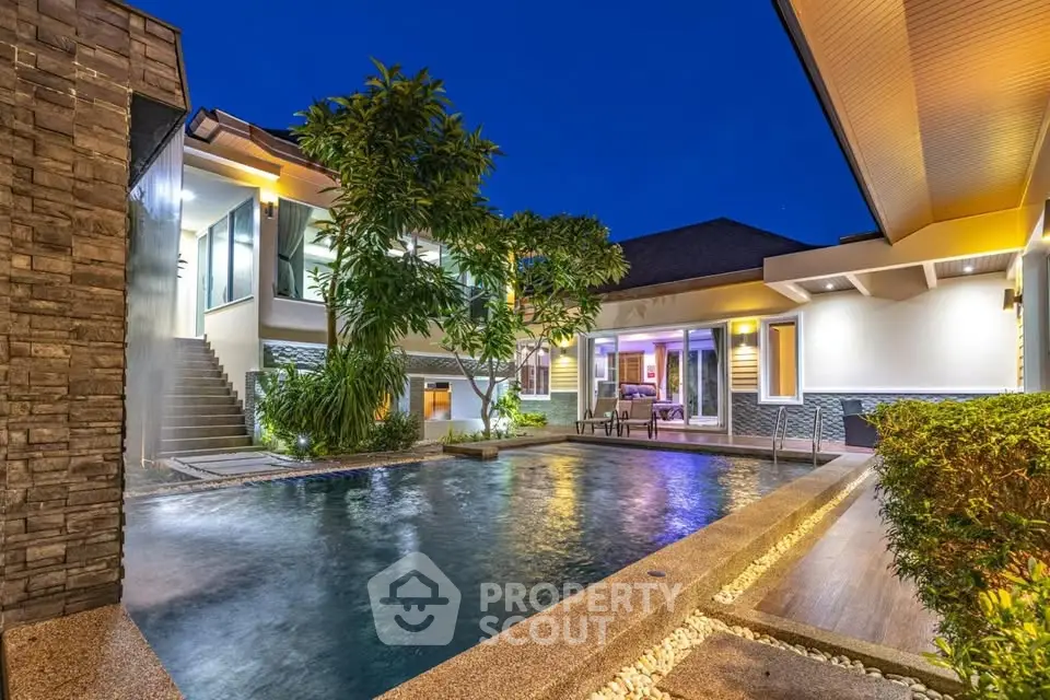 Luxurious modern villa with stunning pool and ambient lighting at dusk.
