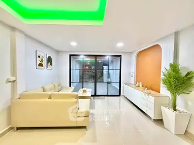 Modern living room with sleek design, featuring a beige sectional sofa, glossy tiled floor, and ambient lighting.