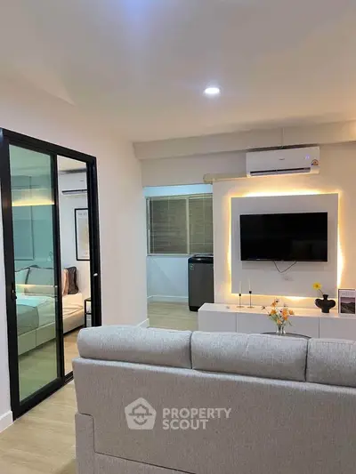 Modern living room with sleek design and illuminated TV wall