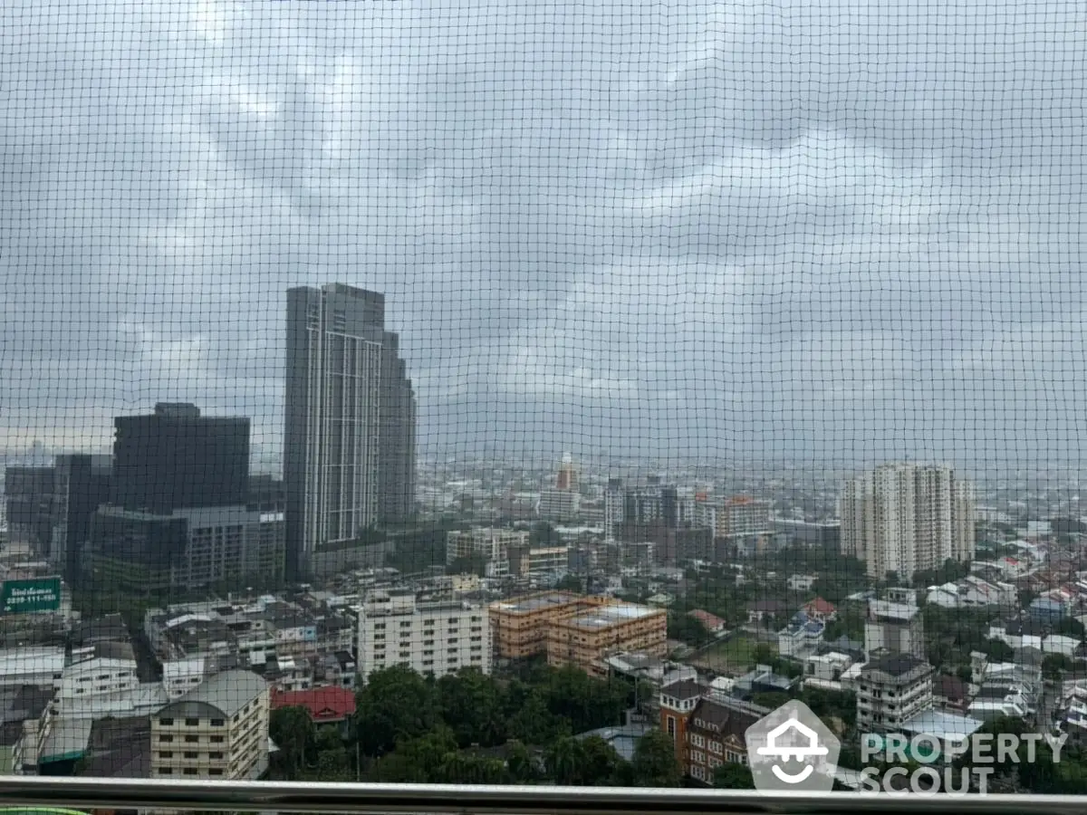 Stunning cityscape view from high-rise building balcony on a cloudy day