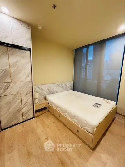 Modern bedroom with city view and stylish marble accents