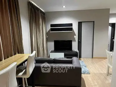 Modern living room with sleek furniture and wooden flooring