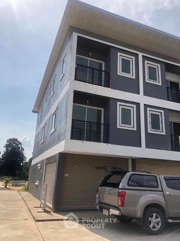 Modern three-story building with parking and sleek design
