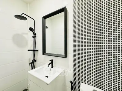 Modern bathroom with sleek black fixtures and stylish mosaic tiles