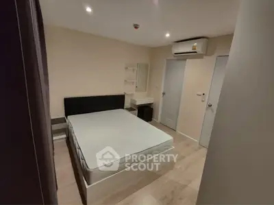 Modern bedroom with minimalist design and air conditioning unit.