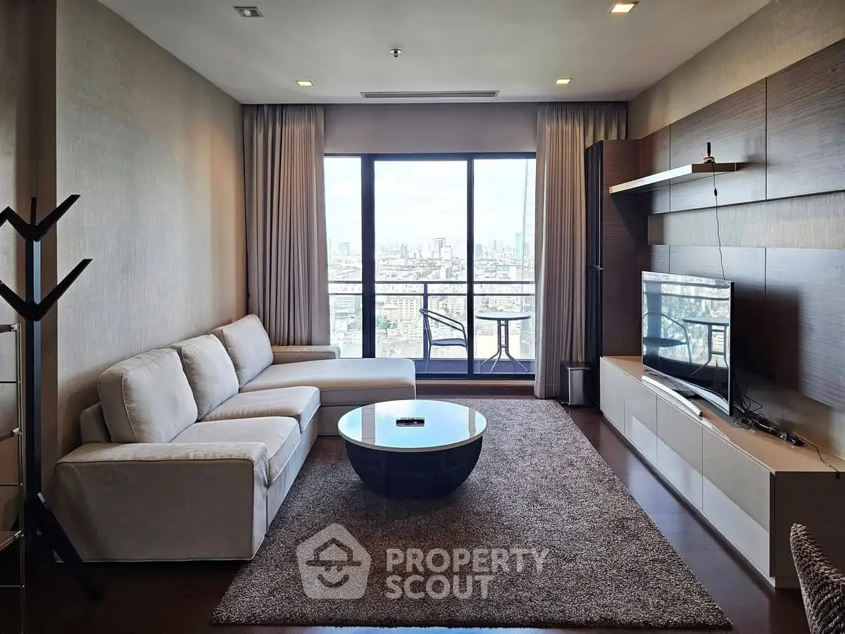 Spacious modern living room with city view, featuring a cozy sectional sofa and entertainment center.