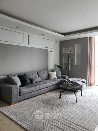 Spacious modern living room with elegant gray sofa and stylish decor