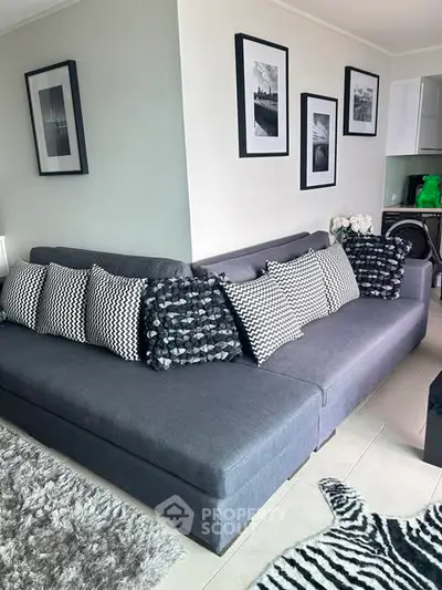 Stylish living room with modern gray sectional sofa and chic monochrome decor