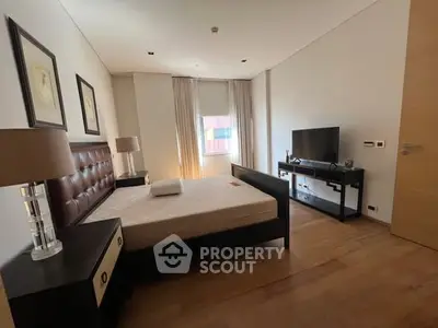 Spacious modern bedroom with elegant decor and natural light