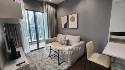 Modern living room with cozy sofa, stylish decor, and balcony view in urban apartment.