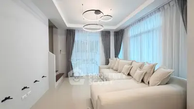 Modern living room with elegant lighting and large windows in a stylish home.