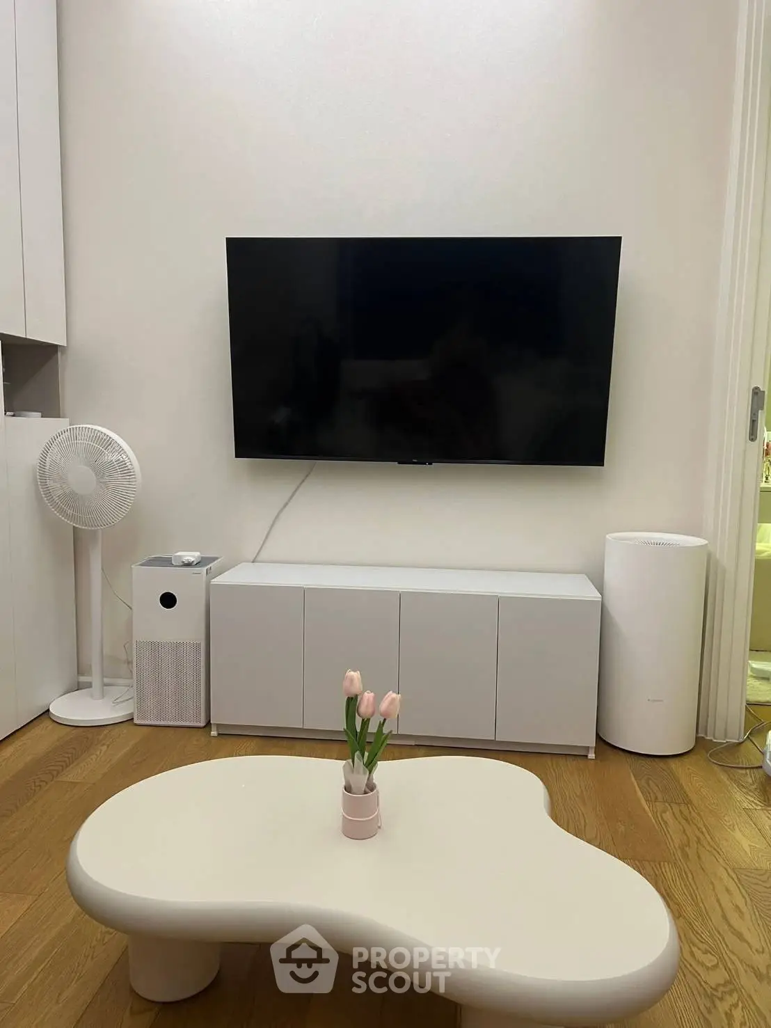 Modern living room with sleek TV setup and minimalist furniture