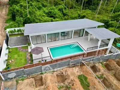 Modern villa with private pool and lush greenery, perfect for luxury living.