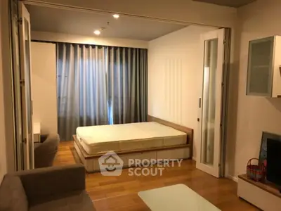 Modern studio apartment with wooden flooring and cozy furnishings