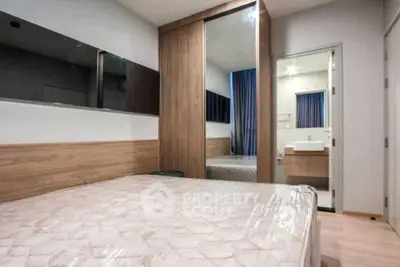 Modern bedroom with stylish wooden wardrobe and ensuite bathroom